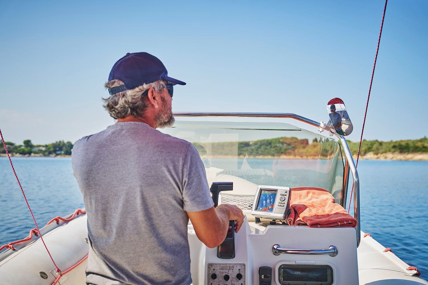Captain Alessandro at the helm steering the boat